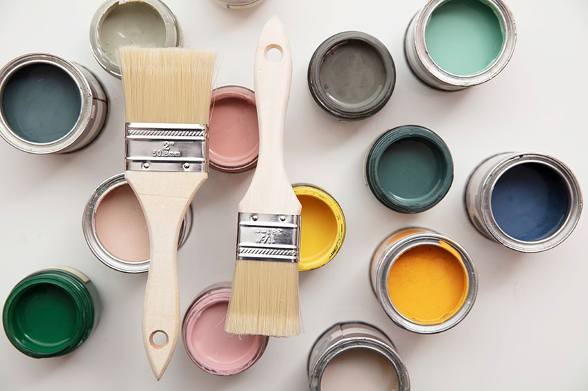 Top view of brushes with colorful paint sample containers