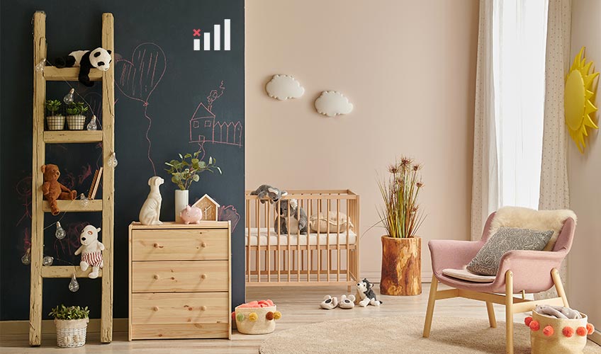 Modern nursery with chalkboard wall and wooden furniture, illustrating low-VOC and non-toxic paint choices for children's spaces