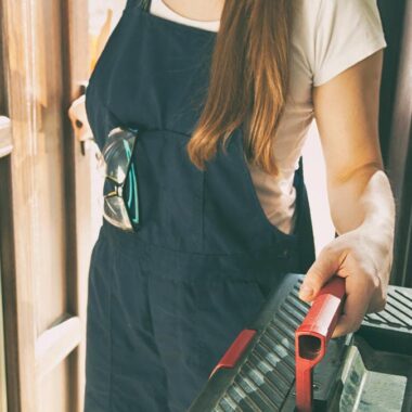 Los Angeles exterior prep contractor carrying tools at a front door, ready to inspect doors and windows for winter rain home protection.