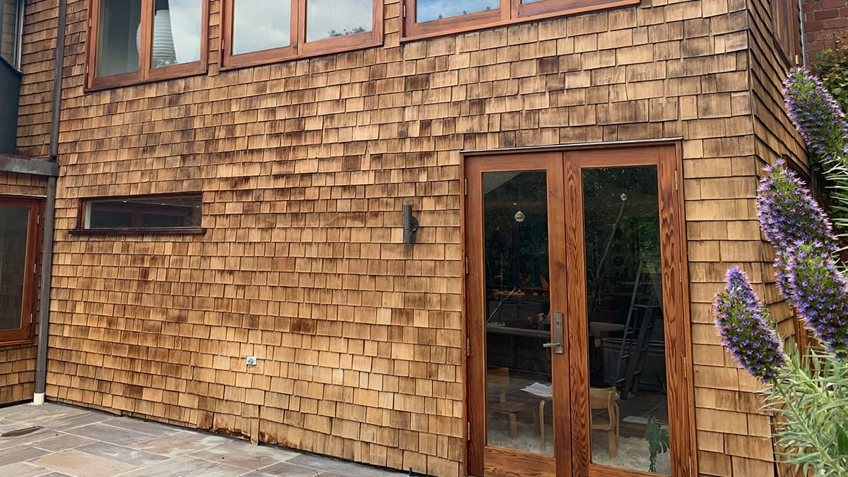 Weathered cedar shingles before professional recoating on a Pacific Palisades home